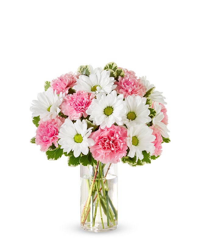 Pink roses, pink carnations and white daisies in a pink vase